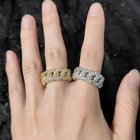 Two iced Cuban link rings on hand โ gold and silver layered ring stacking 2-2 rule visual demonstration