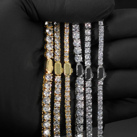 Gold and silver iced out tennis chains showing the single-row prong-set structure of a tennis chain