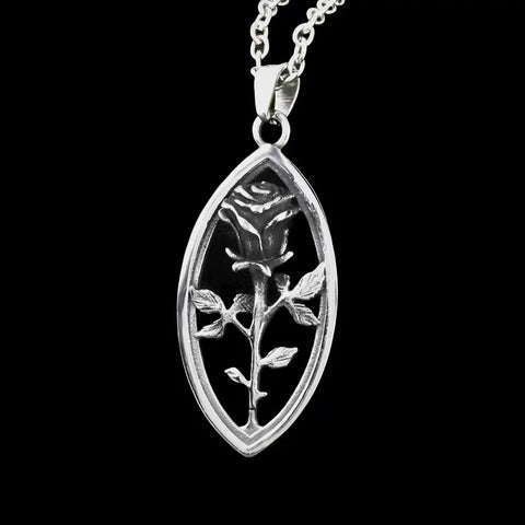 rose pendant meaning shown by a sculpted silver rose necklace