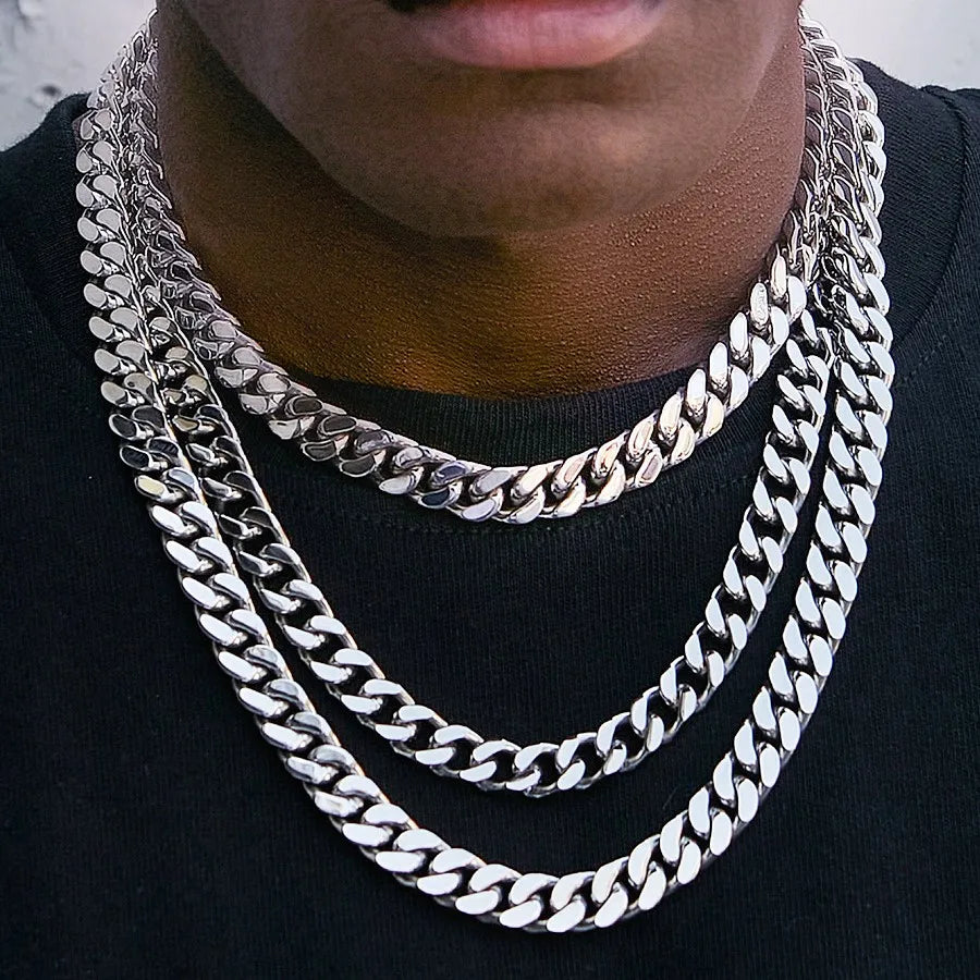 Silver Cuban link chain on a neck — the classic best first chain for men
