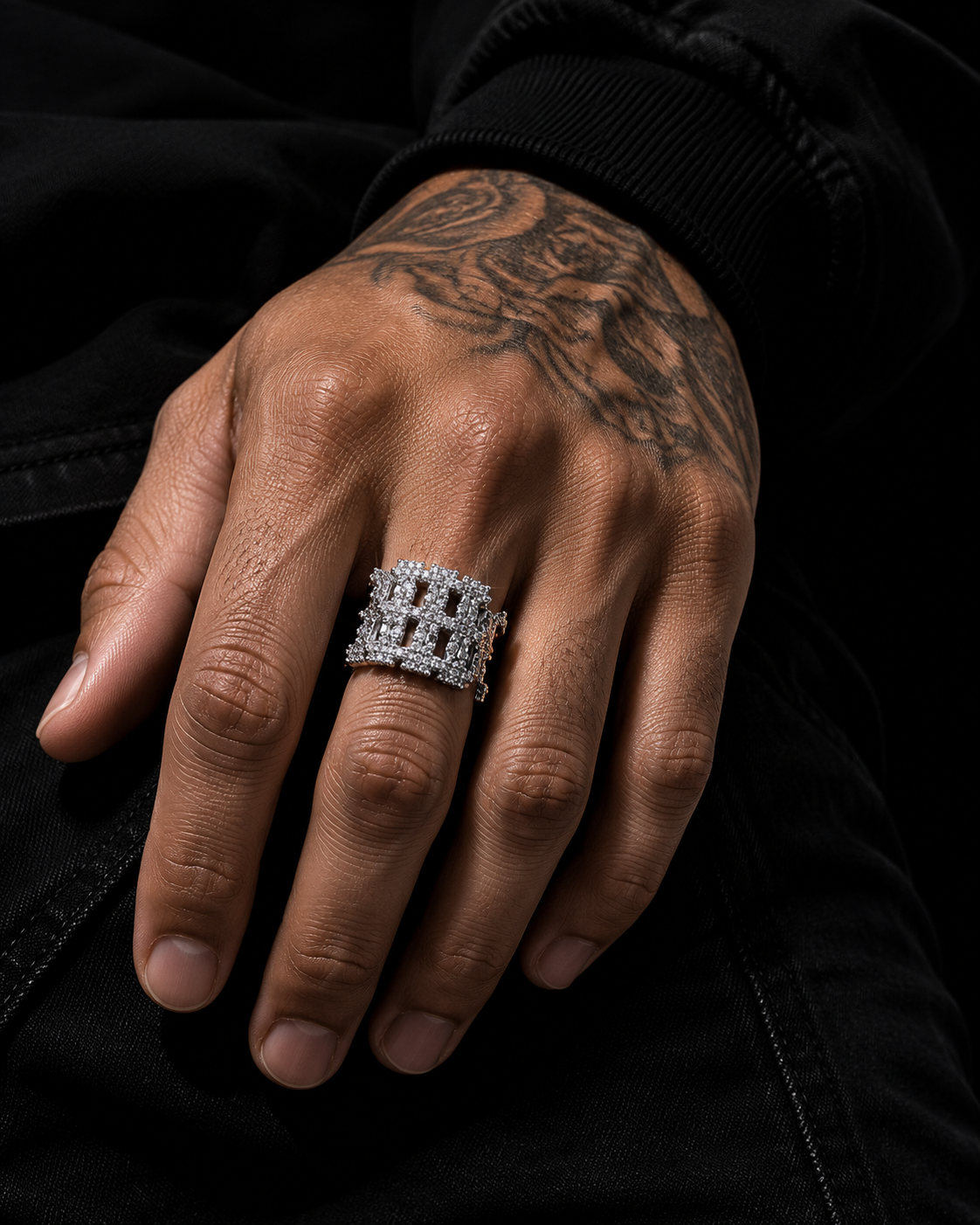 DRIPLORE iced-out cross cuban band ring worn on male hand, black background, cold studio lighting, streetwear